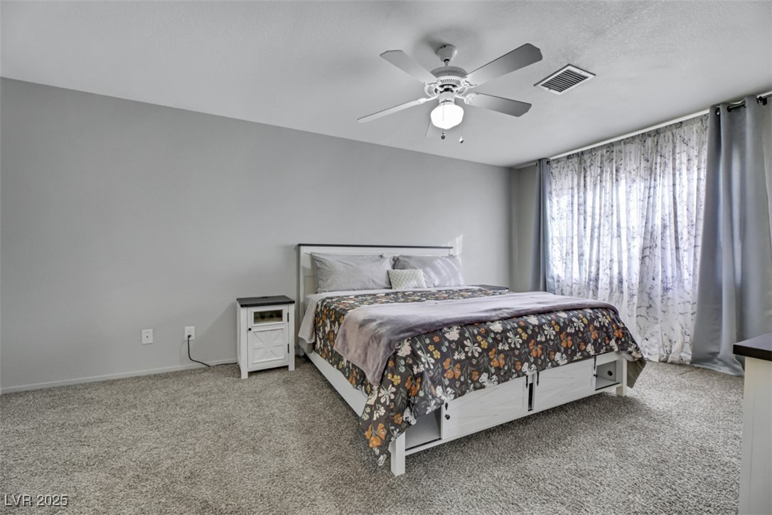 2907 Rio Sonora Court Henderson, NV 89074 - Photo 17 of 35 Bedroom with light carpet and ceiling fan