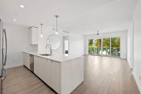 a kitchen with stainless steel appliances a refrigerator sink and wooden cabinets