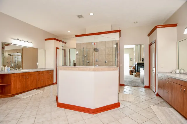 a large kitchen with kitchen island granite countertop a large window and a sink