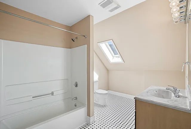 a bathroom with a bathtub and a shower