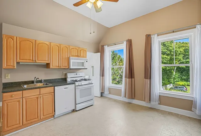 a kitchen with a sink stove and cabinets