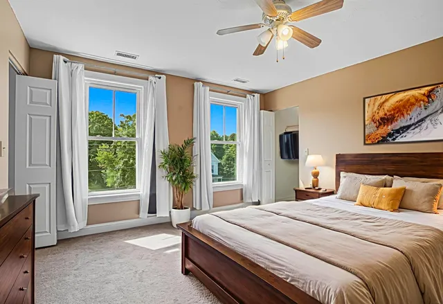 a bedroom with a large bed and a window