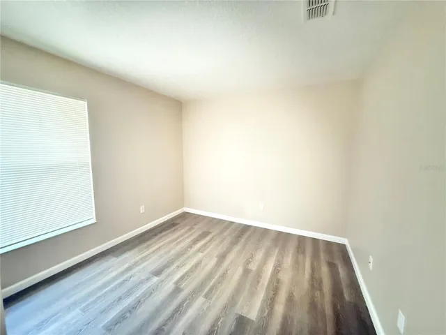 a view of room with window and hardwood floor