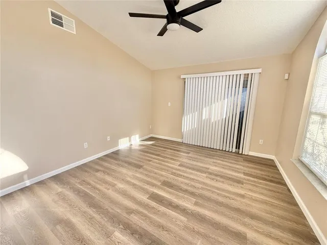 a view of a livingroom with wooden floor and window