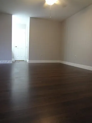 a view of wooden floor and windows in a room