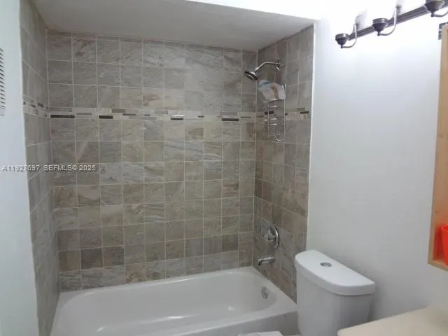 a view of a small space with wooden floor and a window