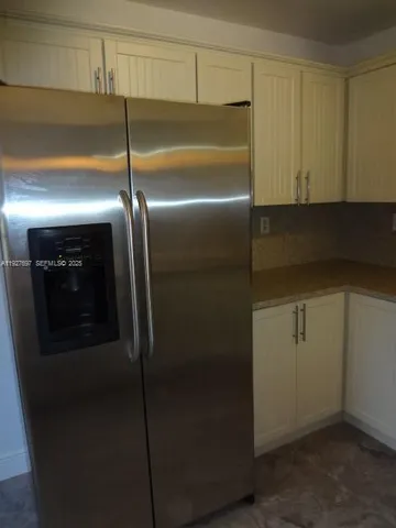a kitchen with granite countertop a stove and a refrigerator