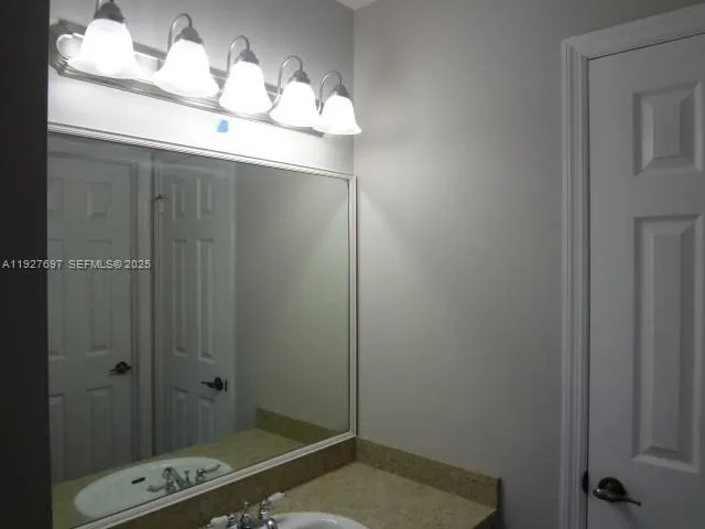 a bathroom with a mirror and a shower