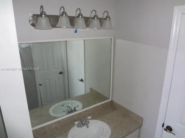 a bathroom with a sink and mirror