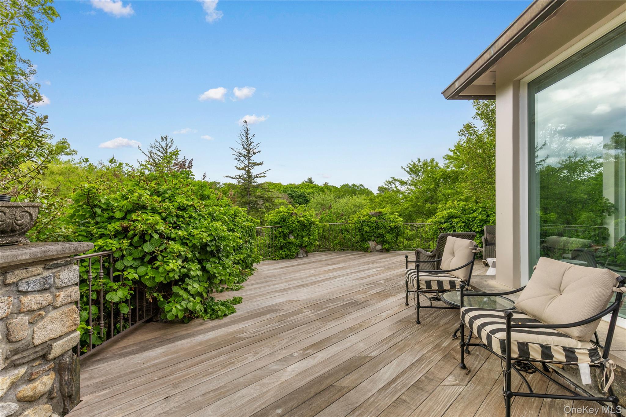 150 Old Farm Road North Chappaqua, NY 10514 - Photo 37 of 44 a view of a chairs and table on the wooden deck