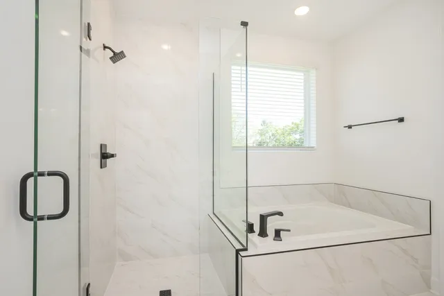 a bathroom with a sink tub and shower