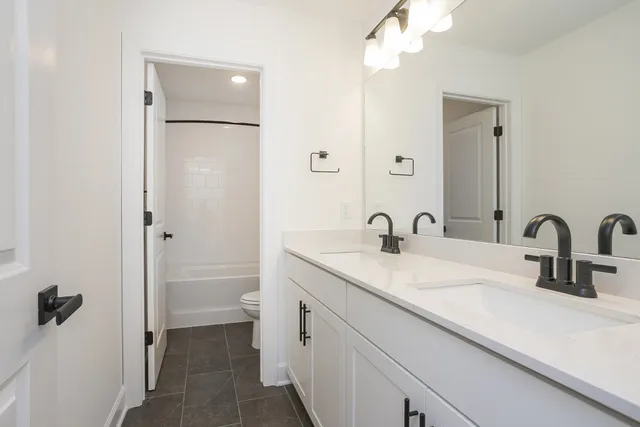 a front view of a house with yard and green space