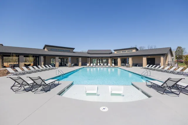 a living room with lots of furniture and a chandelier