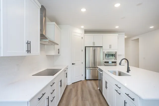 a kitchen with refrigerator cabinets and wooden floor