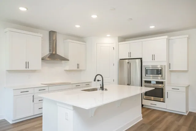 a kitchen with a sink stainless steel appliances and cabinets