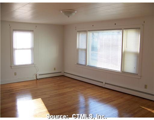 21 Strosberg Road Waterford, CT 06385 - Photo 1 of 1 a view of an empty room with wooden floor and a window