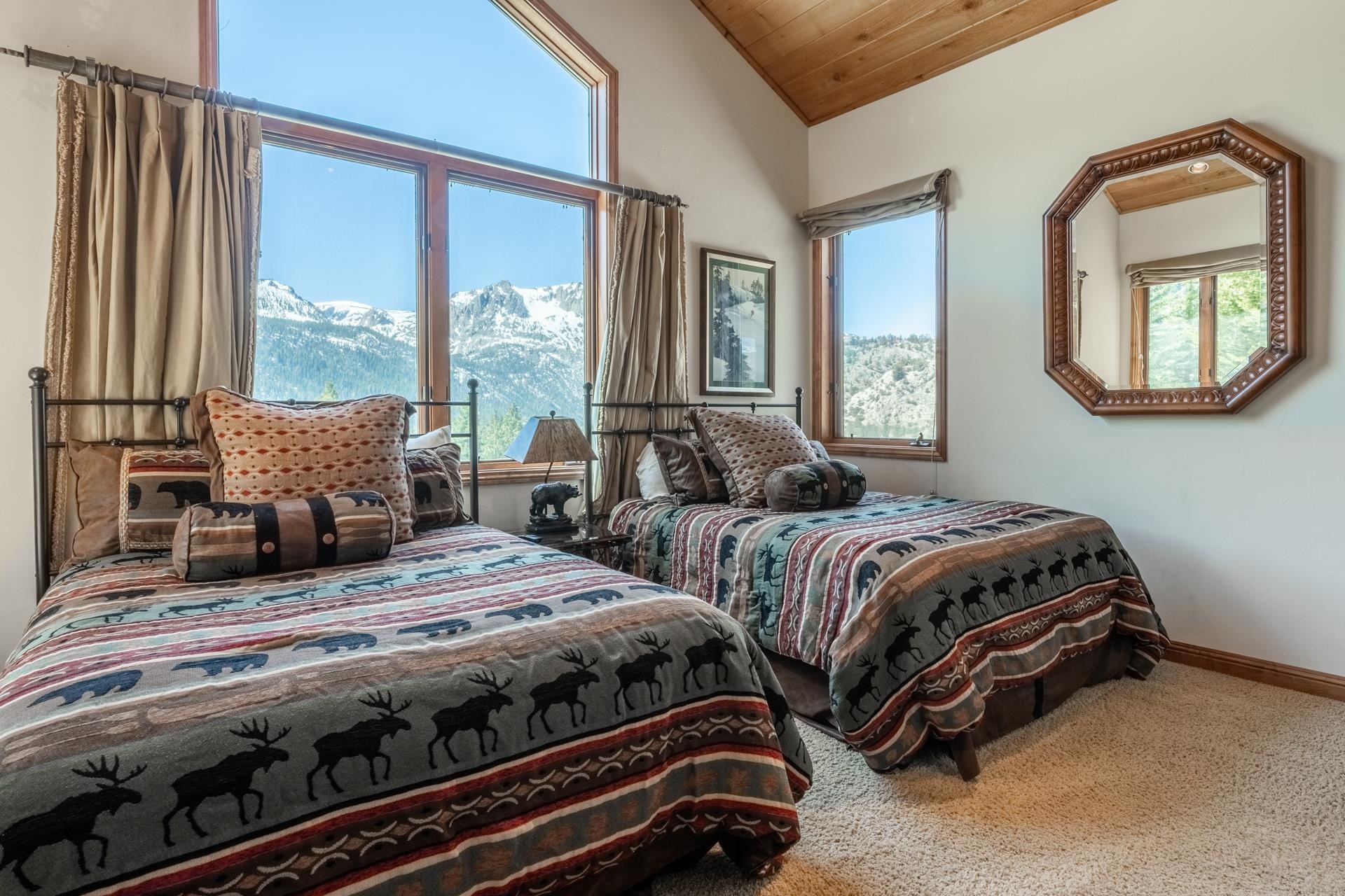 45 Skyline Road June Lake, CA 93529 - Photo 36 of 58 Vaulted wood-paneled ceiling, large windows with mountain scenery, and light beige carpet flooring
