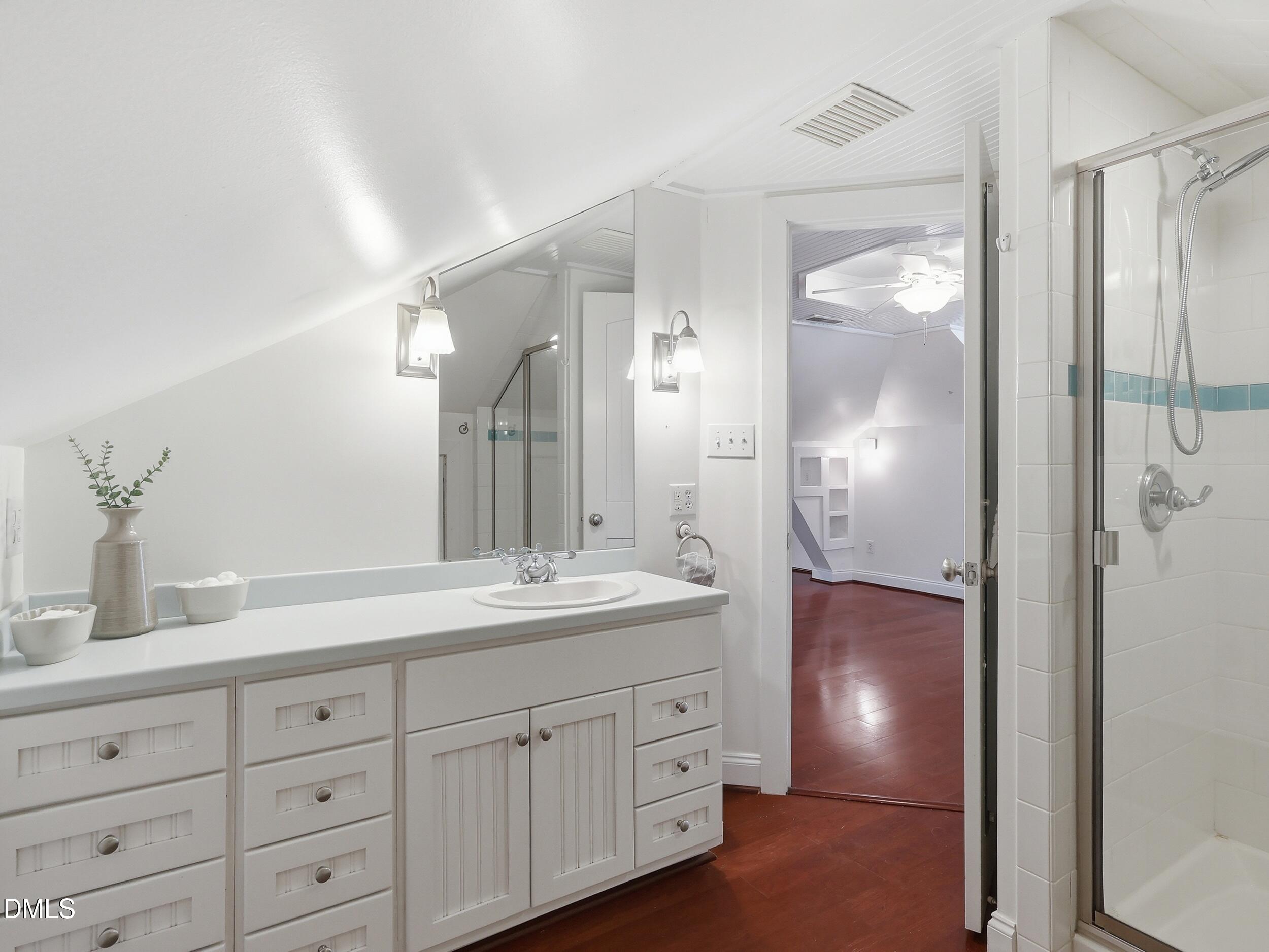 127 Forest Road Raleigh, NC 27605 - Photo 70 of 75 a spacious bathroom with double sink a shower and a mirror