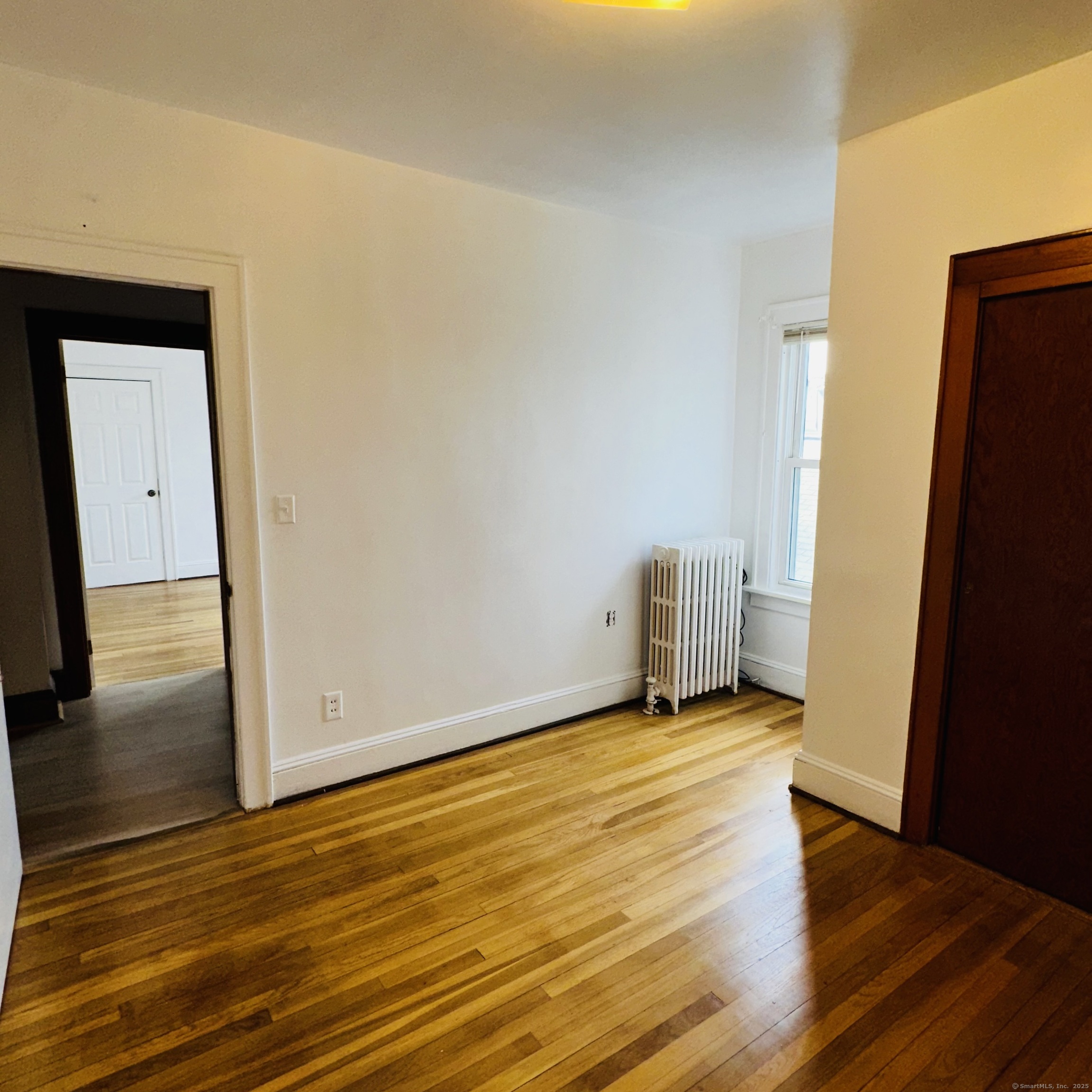 20 Amaryllis Avenue Waterbury, CT 06710 - Photo 12 of 21 a view of an empty room with wooden floor and a window