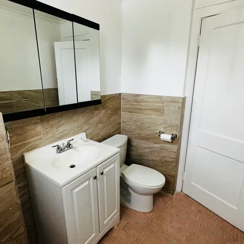 a bathroom with a sink a toilet and mirror