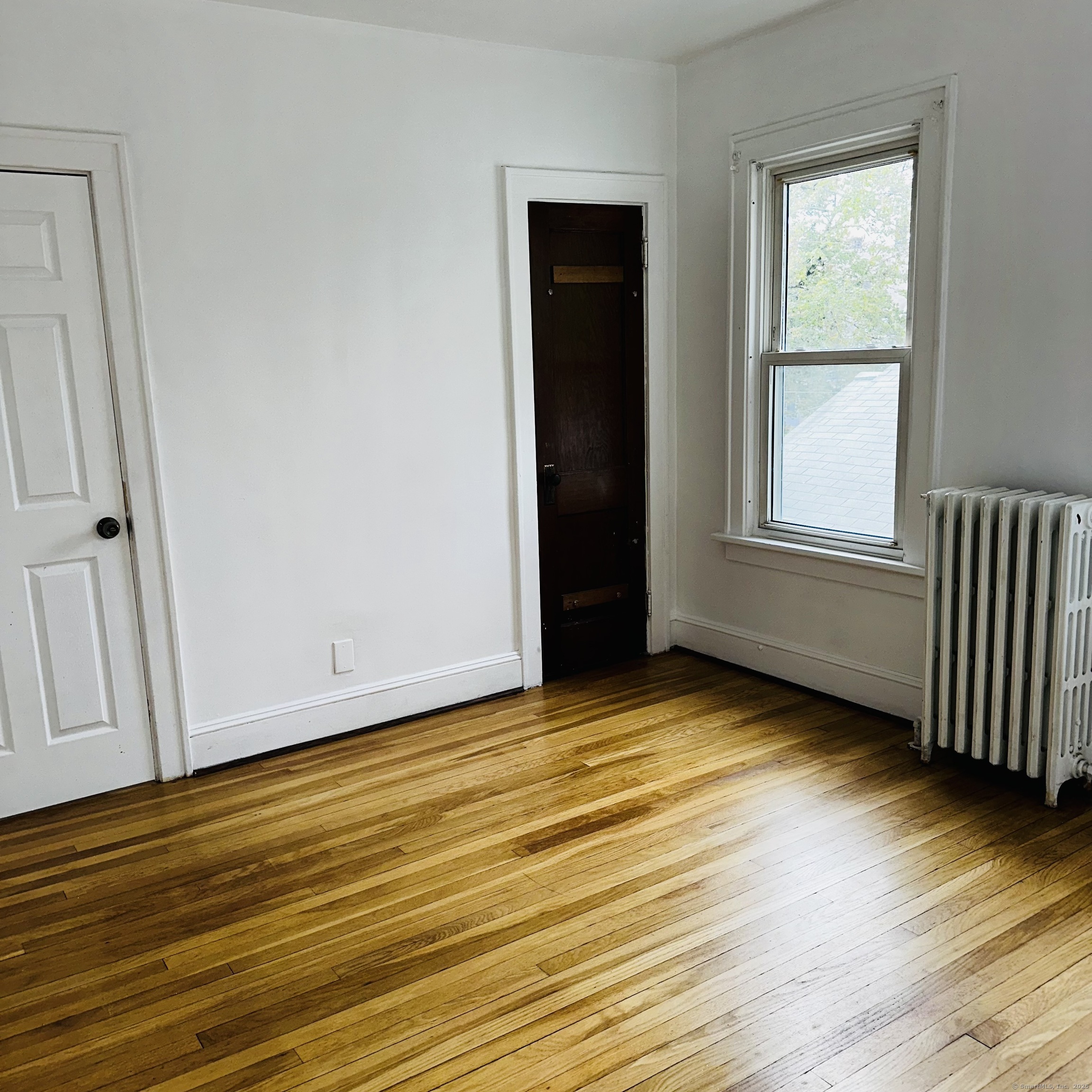 20 Amaryllis Avenue Waterbury, CT 06710 - Photo 15 of 21 a view of an empty room with wooden floor and a window