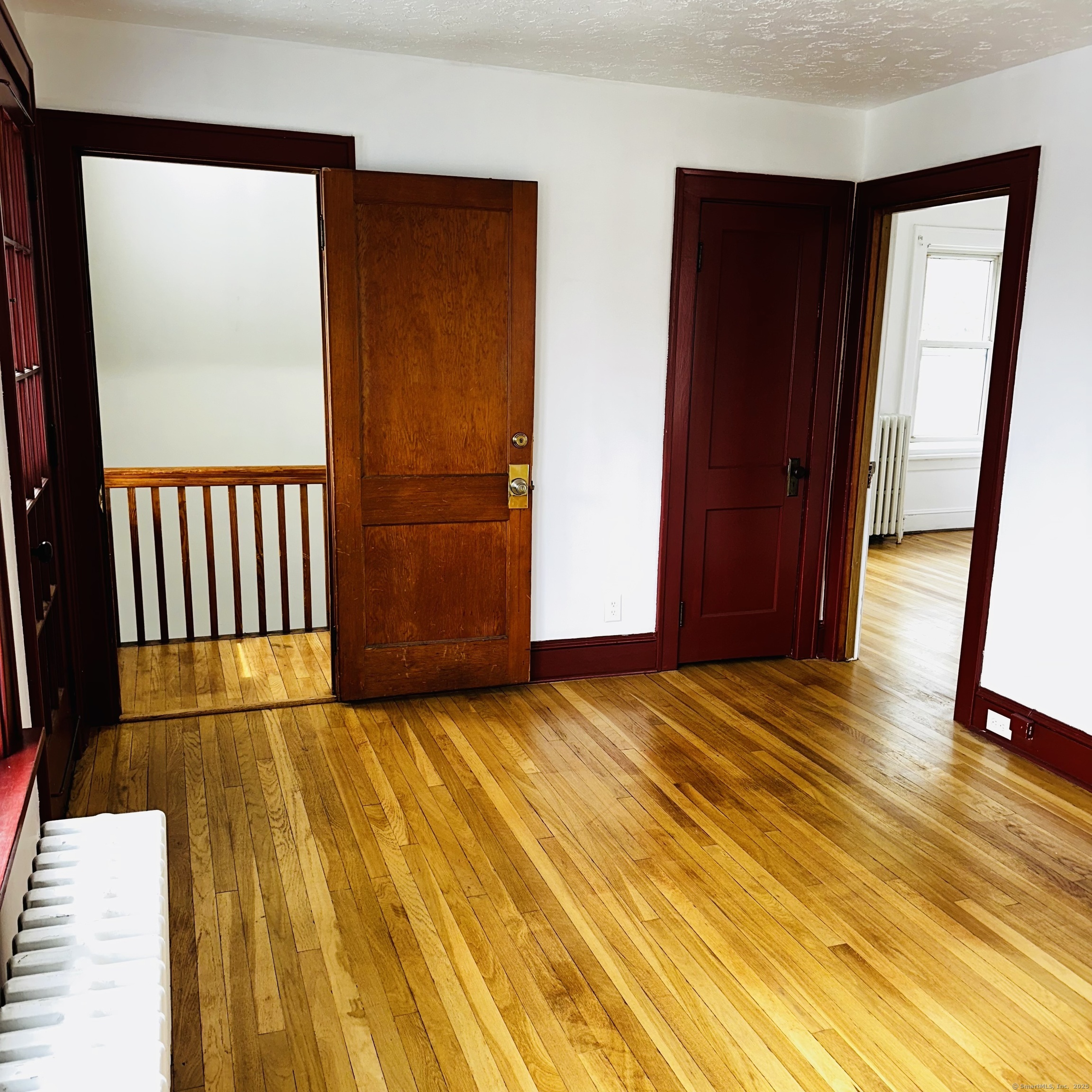 20 Amaryllis Avenue Waterbury, CT 06710 - Photo 3 of 21 a view of an empty room with wooden floor and a window