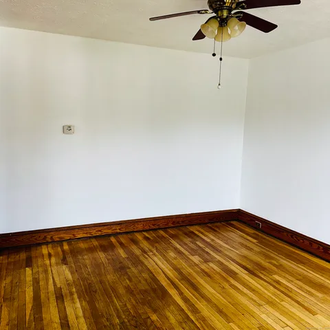 a view of a room with a ceiling fan and a window