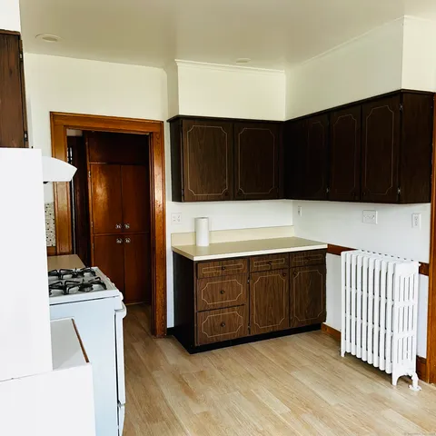 a kitchen with stainless steel appliances a cabinets and a stove top oven