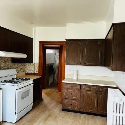 a kitchen with wooden cabinets and a stove