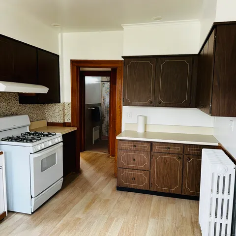 a kitchen with granite countertop a stove and a cabinets