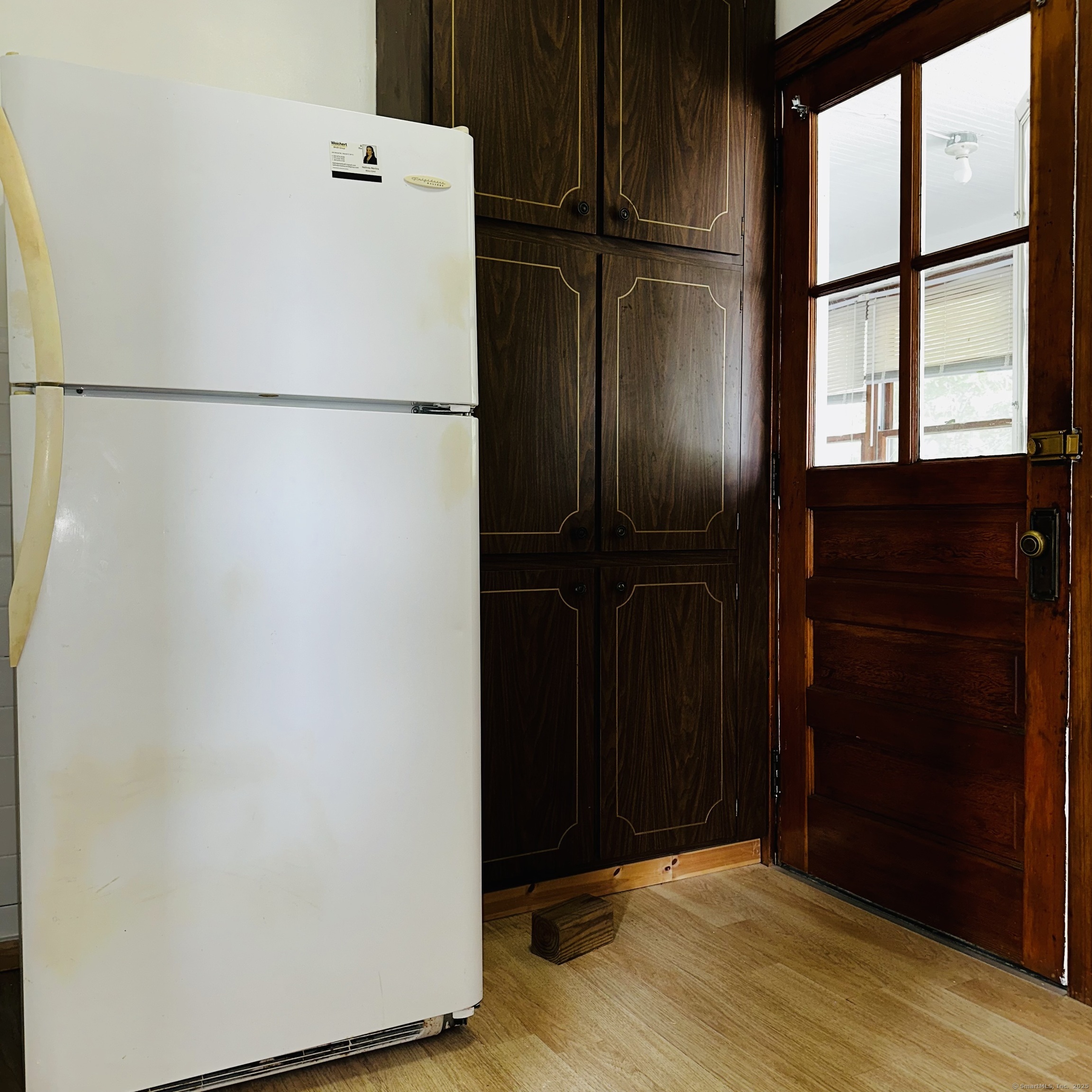 20 Amaryllis Avenue Waterbury, CT 06710 - Photo 10 of 21 a view of a refrigerator in kitchen and wooden floor