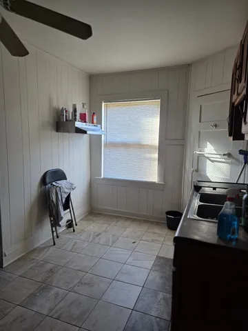 a living room with furniture a air conditioner vent and a window