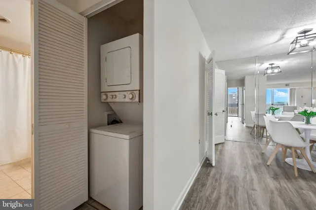 a view of a hallway and wooden floor windows and a kitchen