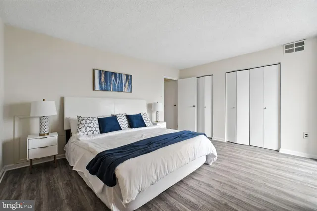 a bedroom with a bed and a night stand