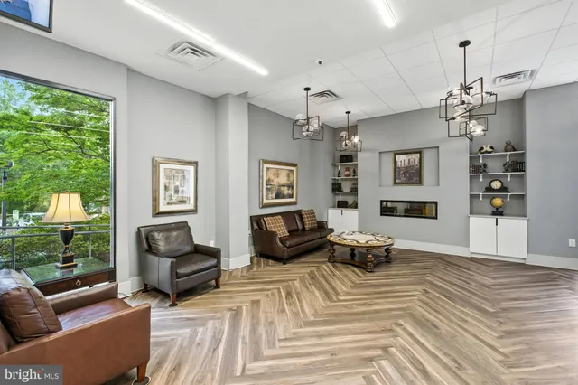 a living room with furniture wooden floor and a chandelier