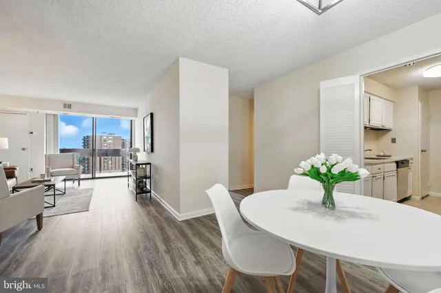 a view of a dining room with furniture wooden floor and a chandelier