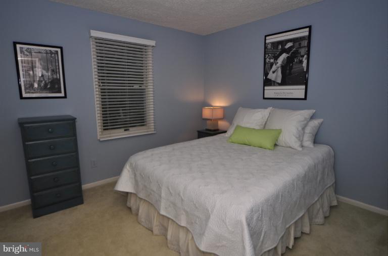 1943 Barton Hill Road Reston, VA 20191 - Photo 3 of 28 a bedroom with a bed a dresser and a window