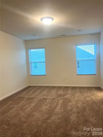 an empty room with a empty space and windows