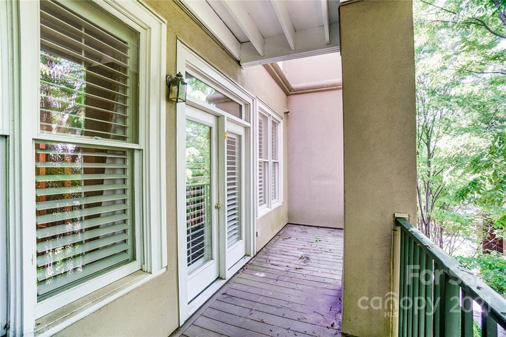 416 Queens Road, Unit 14 Charlotte, NC 28207 - Photo 11 of 27 a view of a balcony with wooden floor and stairs
