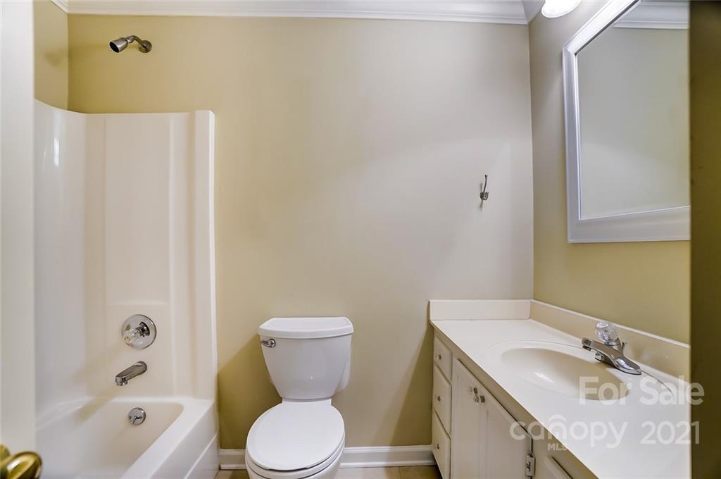 416 Queens Road, Unit 14 Charlotte, NC 28207 - Photo 18 of 27 a bathroom with a granite countertop sink toilet and shower