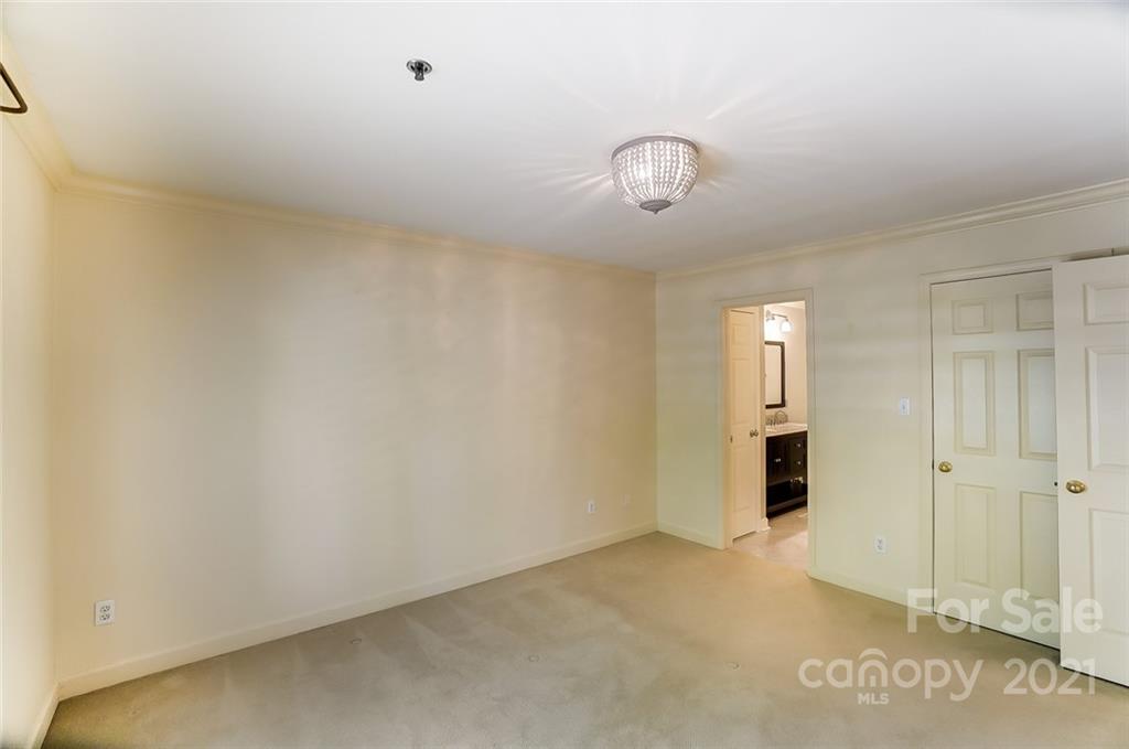 416 Queens Road, Unit 14 Charlotte, NC 28207 - Photo 22 of 27 an empty room with windows