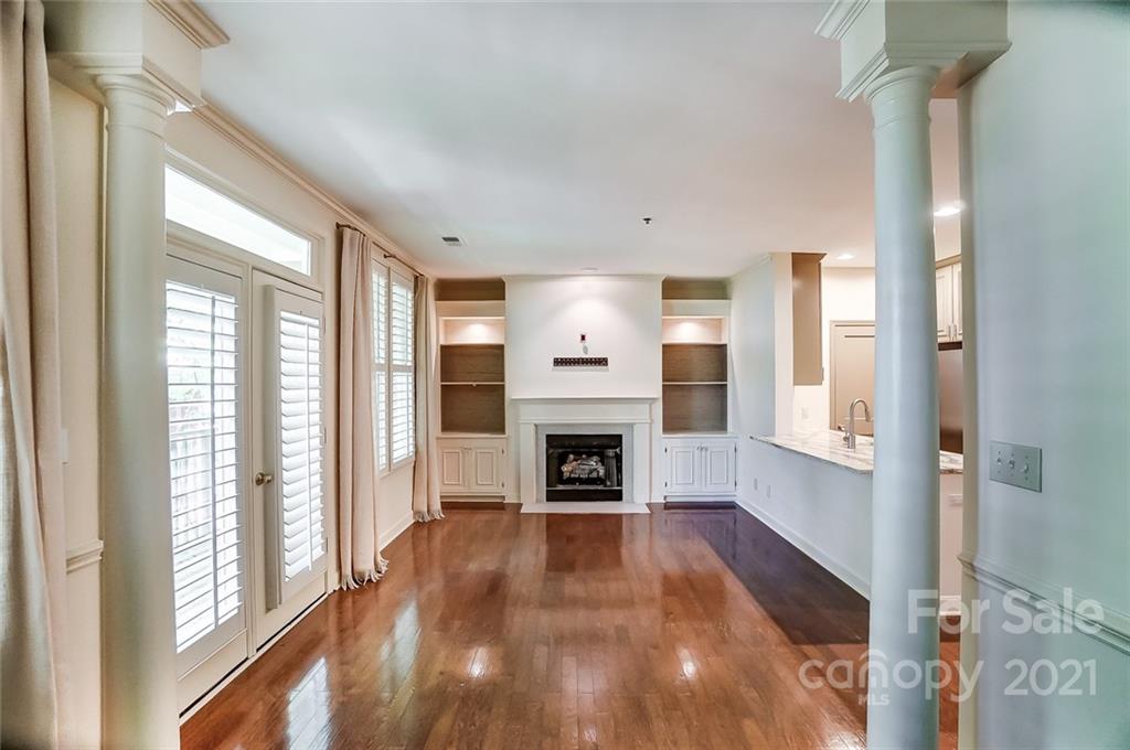 416 Queens Road, Unit 14 Charlotte, NC 28207 - Photo 5 of 27 a view of a livingroom with a fireplace wooden floor and windows