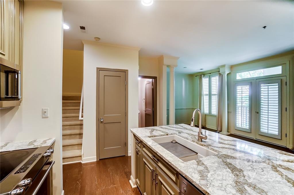 416 Queens Road, Unit 14 Charlotte, NC 28207 - Photo 7 of 27 a bathroom with a granite countertop sink and a mirror