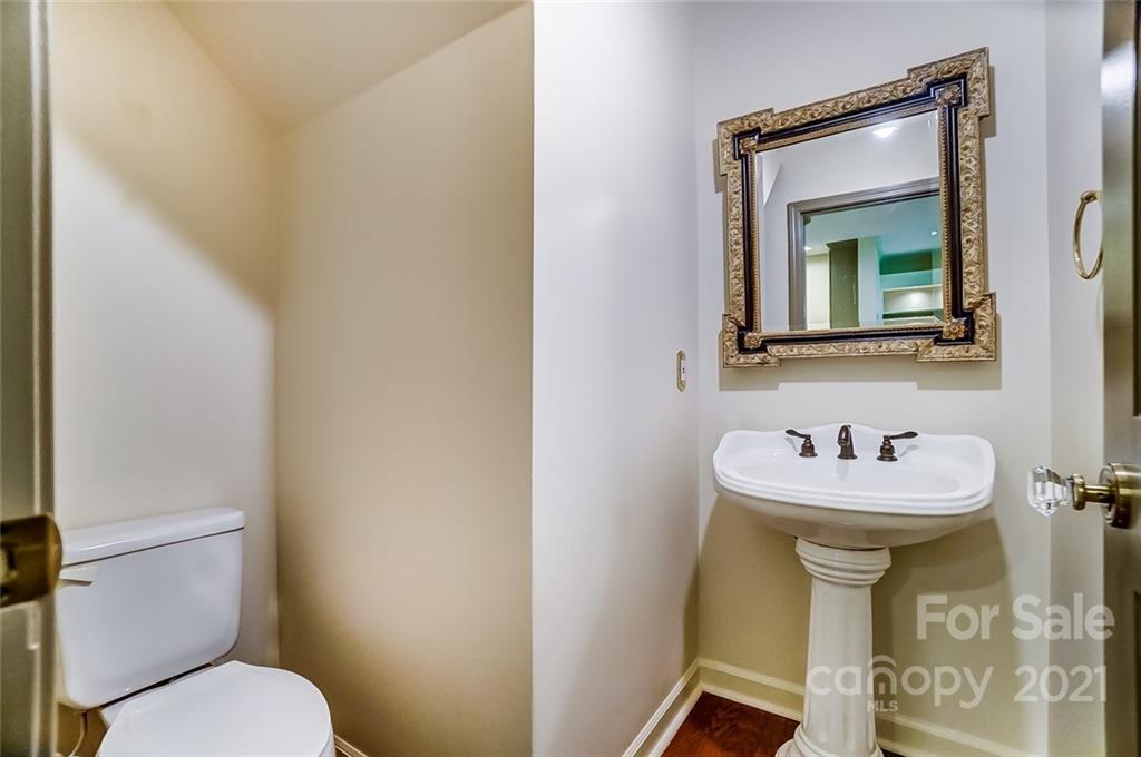 416 Queens Road, Unit 14 Charlotte, NC 28207 - Photo 10 of 27 a bathroom with a sink mirror and toilet