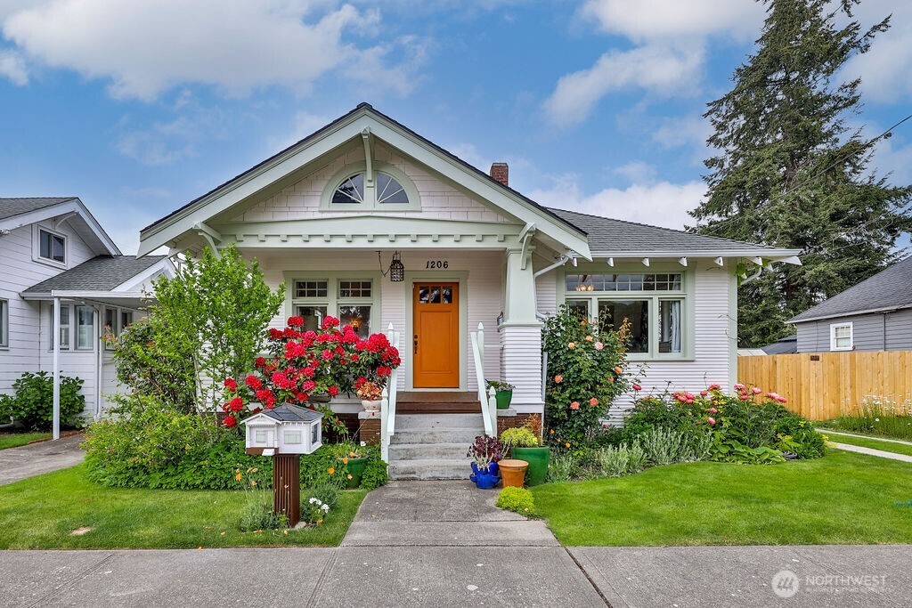 a front view of a house with a garden