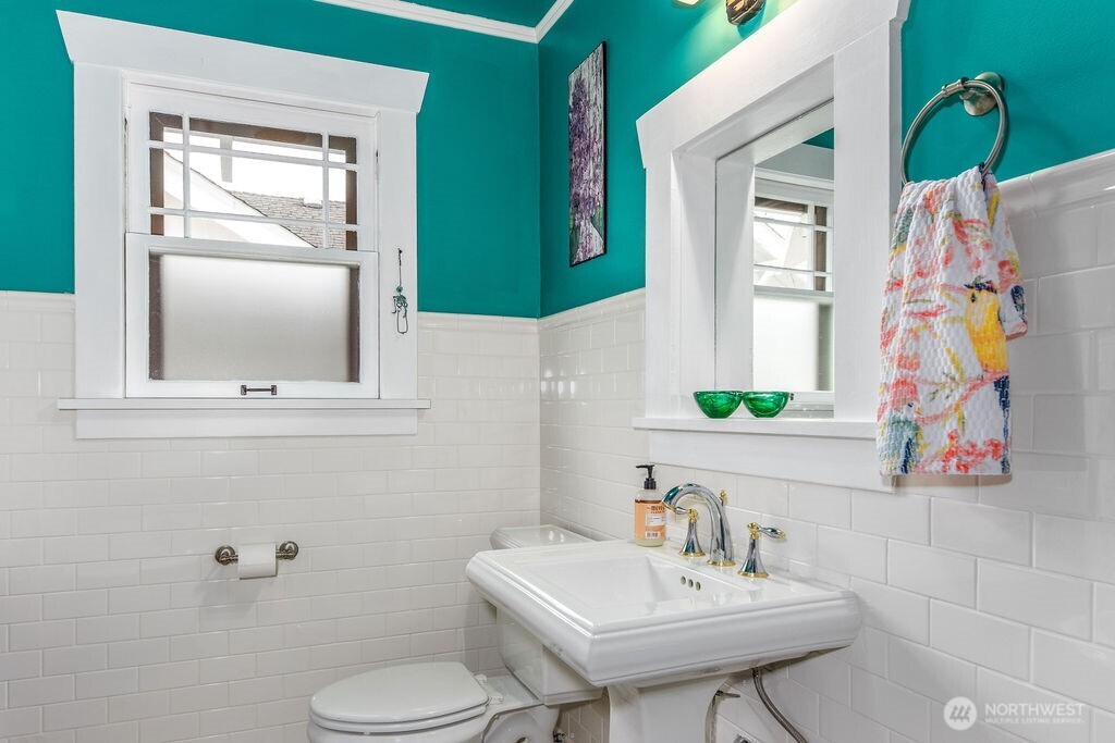 1206 North 2nd Street Renton, WA 98057 - Photo 11 of 24 a bathroom with a sink a toilet and mirror