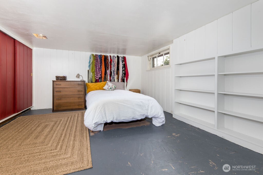 1206 North 2nd Street Renton, WA 98057 - Photo 13 of 24 a bedroom with a bed and a book shelf