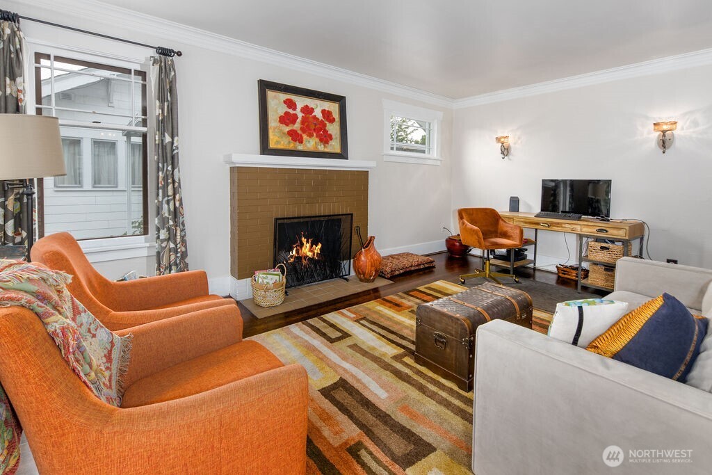 1206 North 2nd Street Renton, WA 98057 - Photo 3 of 24 a living room with furniture a flat screen tv and a fireplace