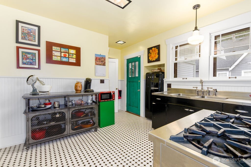 1206 North 2nd Street Renton, WA 98057 - Photo 6 of 24 a kitchen with stainless steel appliances granite countertop a stove and cabinets