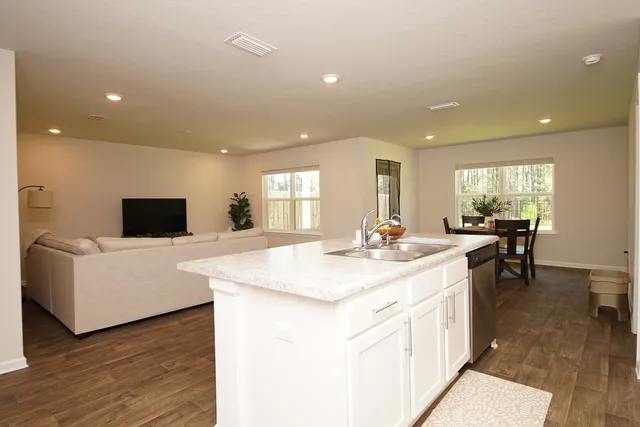 a kitchen with stainless steel appliances granite countertop a refrigerator stove and sink